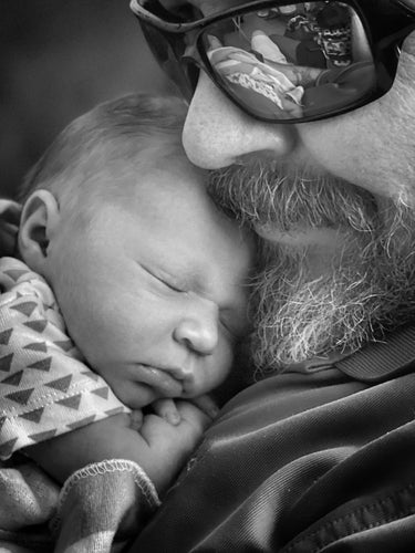 Me holding my granddaughter as she naps on my chest.