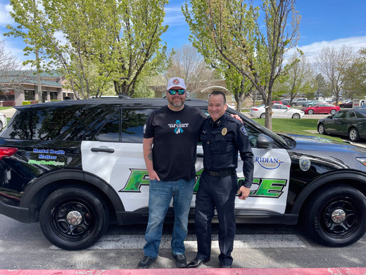 Myself posing with the Chief of Police from Meridian at the unveiling of there mental health themed patrol car.